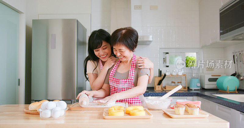 mom and daughter making bread